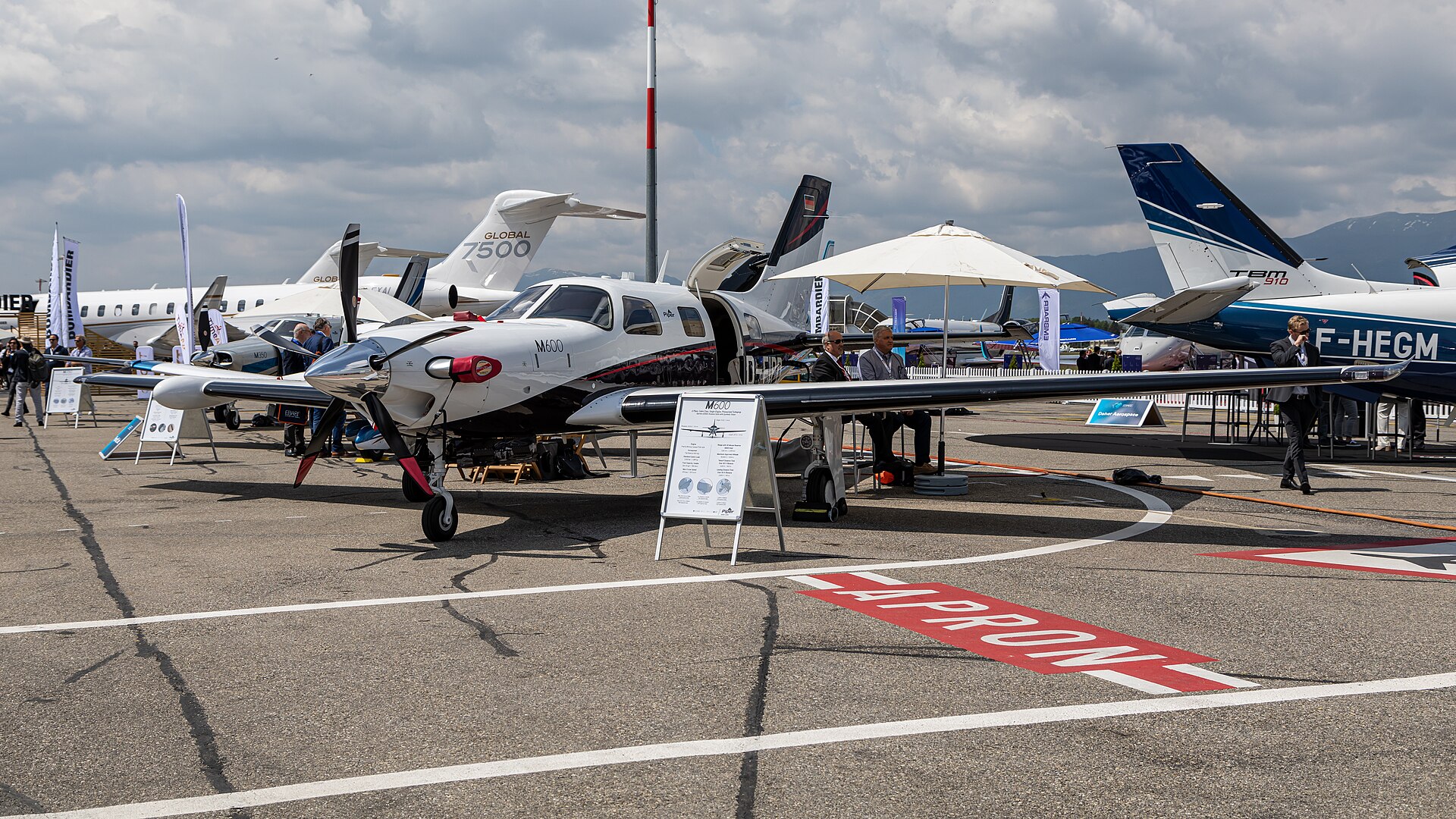 A row of business jets, including a Bombardier Global 7500, on a display apron